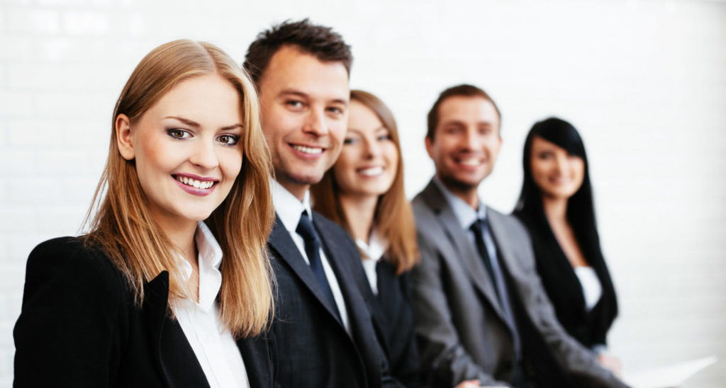 Group of happy business people sitting in a row